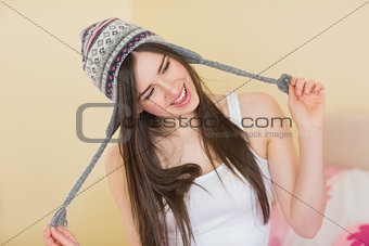 Silly pretty girl trying on a wool hat