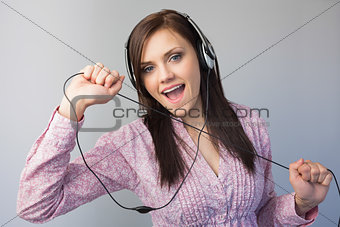 Cheerful young brunette listening to music