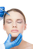 Relaxed attractive model having botox injection on the forehead