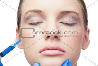 Peaceful pretty model having botox injection on the cheek