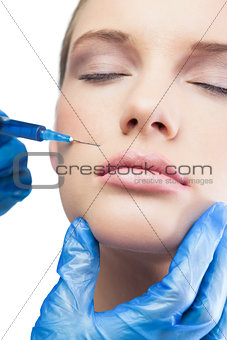 Relaxed pretty model having botox injection above the lips