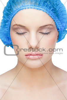 Relaxed pretty model wearing blue surgical cap