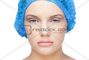 Content pretty model wearing blue surgical cap