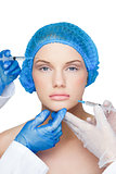 Surgeons making injection on content blonde wearing blue surgical cap
