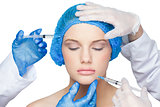 Surgeons making injection on calm blonde