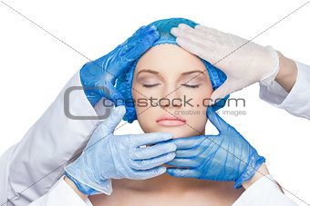 Surgeons examining peaceful blonde