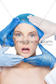 Surgeons examining surprised blonde