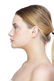 Profile view of calm pretty blonde with dotted lines on the face