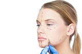 Surgeon drawing dotted lines on pretty patient