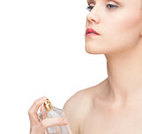 Beautiful nude model spraying perfume