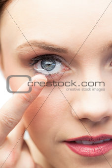 Pretty model applying contact lens