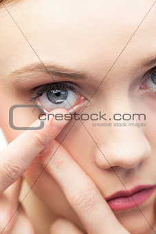 Cute model applying contact lens