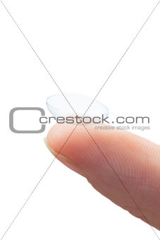 Extreme close up on finger holding contact lens