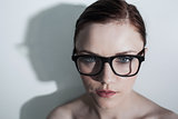 Serious clean model with classy glasses posing