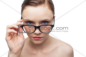 Serious clean model looking over her classy glasses