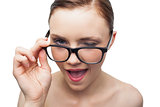 Cheerful model winking at camera over her classy glasses
