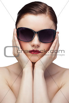 Serious young model wearing stylish sunglasses