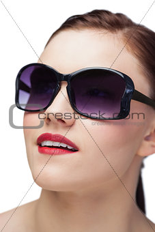 Smiling sensual model wearing classy sunglasses