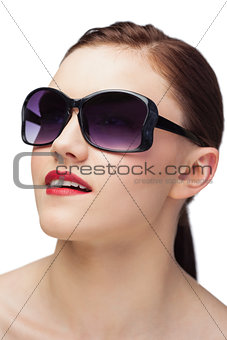 Cheerful sensual model wearing classy sunglasses