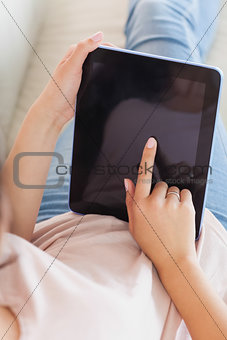 Girl using her tablet on the couch