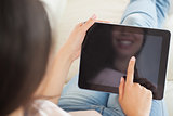 Girl using her tablet pc on the couch