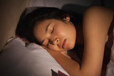 Young asian woman sleeping peacefully at night