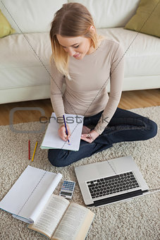 Smiling woman working on homework