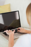 Blonde woman typing on laptop