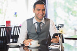 Businessman in a restaurant holding phone