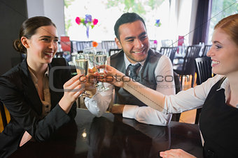 Three business people toasting their success