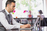 Concentrated businessman working on laptop