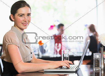 Attractive businesswoman working on laptop