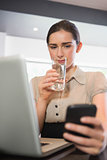 Businesswoman drinking water in a cafe