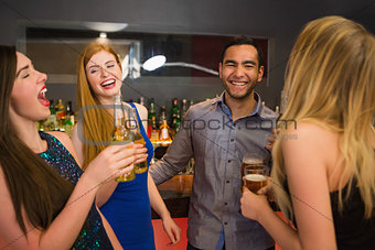 Laughing friends drinking beers