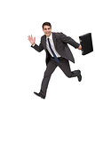Happy businessman holding a briefcase and running
