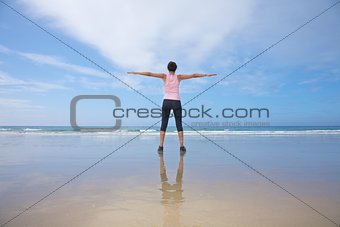 woman exercising on seashore