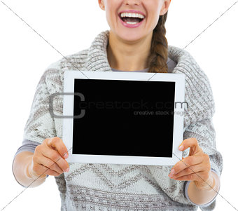 Closeup on smiling young woman showing tablet pc blank screen