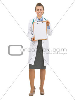 Full length portrait of doctor woman showing blank clipboard