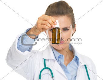 Closeup on medicine bottle in hand of doctor woman