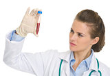 Doctor woman looking on test tube