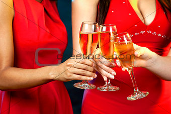 women holding champagne glasses