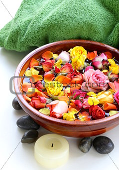 wooden bowl with roses and petals of flowers - spa concept