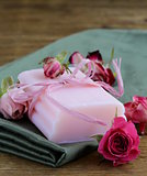 homemade soap with roses on a wooden table
