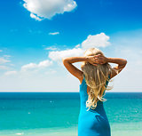 Woman in Turquoise Dress at the Sea. Rear View.