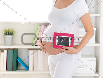Pregnant woman and ultrasound scan photo