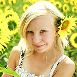 Beautiful portrait of summer young girl in the field of sunflowe