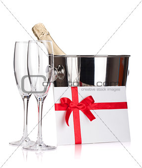 Two champagne glasses, bottle in bucket and letter