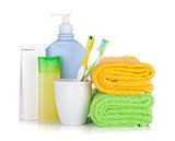 Toothbrushes, cosmetics bottles and two towels