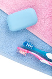 Toothbrushes and soap over towel