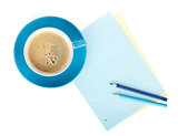 Blue coffee cup, blank paper and two pencils